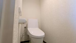 a bathroom with a white toilet in a room at 瀬戸内リゾートホテル in Matsuyama