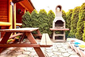 una mesa de picnic y una parrilla en el patio en Domy z Bala - Bungalow 50 metrów od Plaży spa domki ogrzewane, en Dziwnówek