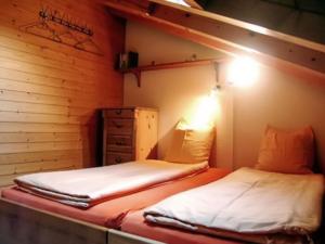 a bedroom with two beds and a dresser in it at Cosy Apartment in Bellwald 68 m² Mountain View in Bellwald