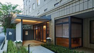 a facade of a building with a glass door at Shin-Osaka Station Hotel in Osaka