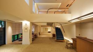 a hallway of a building with a staircase and a stair case at Shin-Osaka Station Hotel in Osaka