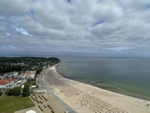 an aerial view of a beach with a bunch of chairs at Beachside 2-Zimmer-Meerblick-Appartement in Lübeck