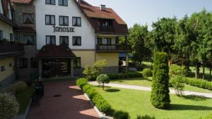 a large white building with a sign on it at DW Janosik in Muszyna