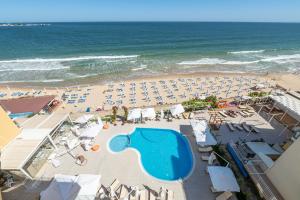 an overhead view of a beach with a swimming pool and the ocean at Perla Apartments First Line in Nesebar