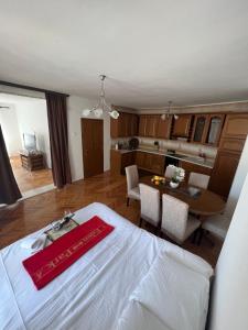 a room with a bed and a kitchen with a table at City Heart Apartments in Ulcinj