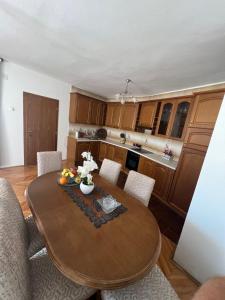 a kitchen with a round wooden table and chairs at City Heart Apartments in Ulcinj