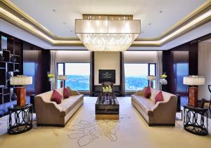 a living room with two couches and a chandelier at Crowne Plaza Chengdu Panda Garden, an IHG Hotel in Chengdu