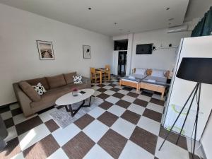 a living room with a couch and a table at Guest house Vila Vedesa in Kotor