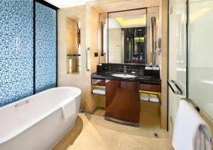 a bathroom with a bath tub and a sink at Crowne Plaza Chengdu Panda Garden, an IHG Hotel in Chengdu