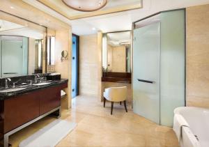 a bathroom with a sink and a glass shower stall at Crowne Plaza Chengdu Panda Garden, an IHG Hotel in Chengdu