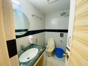 a bathroom with a sink and a toilet at Hotel Grand Akther in Sylhet