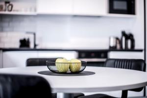 a bowl of fruit on a table in a kitchen at Apartmenthouse STERN in Vipiteno