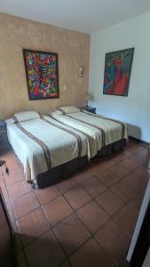 two beds sitting next to each other in a room at Casa Elena in Antigua Guatemala