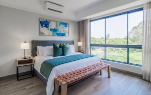 a bedroom with a large bed and a large window at STAY Menlyn in Pretoria