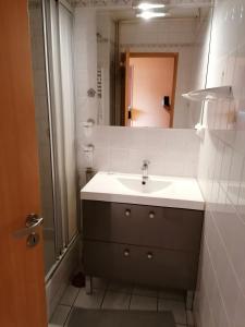 a bathroom with a sink and a mirror at Chambre 1 lit double in Strasbourg