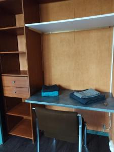 a desk in a room with a closet at Chambre 1 lit double in Strasbourg