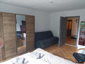 a living room with a bed and a couch at Starling Loka in Škofja Loka