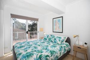 Denhams Beach side holiday apartment tesisinde bir odada yatak veya yataklar