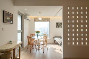 a kitchen and dining room with a table and chairs at Shanghai Yi Du B&B - Near Nanjing West Road commercial district, 350 walk from the Natural History Museum subway in Shanghai