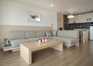 a living room with a couch and a coffee table at Kensington Resort Gyeongju in Gyeongju