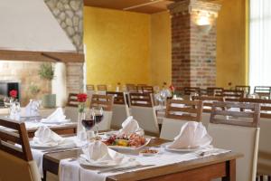 a dining room with a table with a plate of food at Hotel Garden Istra Plava Laguna in Umag