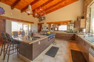 a large kitchen with wooden ceilings and wooden counters at Vistas Tapalpa in Tapalpa