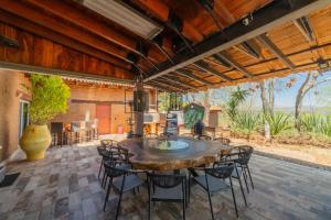 an outdoor dining room with a large wooden table and chairs at Vistas Tapalpa in Tapalpa