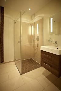 a bathroom with a shower and a sink at Hotel Am Helmwartsturm in Andernach