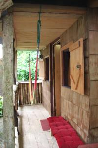 an outside view of a house with red cushions on the floor at Natty Tropical Valley in Roseau