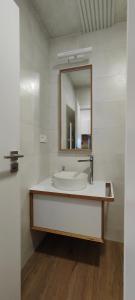 a bathroom with a sink and a mirror at HANESI apartments Luhačovice in Luhačovice