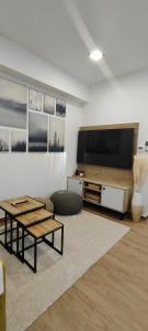 a living room with a large flat screen tv at HANESI apartments Luhačovice in Luhačovice