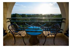 een tafel en stoelen op een balkon met uitzicht bij Parkview Safari Hotel & Apartments in Kisumu