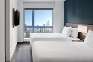 Ένα ή περισσότερα κρεβάτια σε δωμάτιο στο Hyatt Place New York Chelsea