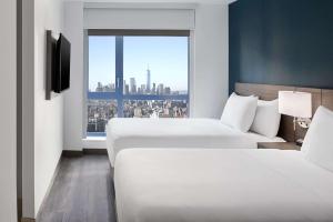 Ένα ή περισσότερα κρεβάτια σε δωμάτιο στο Hyatt Place New York Chelsea