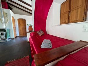 a room with two beds with red sheets at Monte novo in Odeceixe