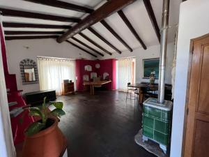 a living room with red walls and a fireplace at Monte novo in Odeceixe