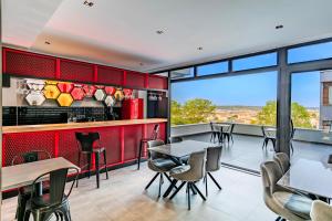 a restaurant with tables and chairs and a view at Intercity Hotel Istanbul Airport in Arnavutköy