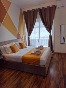 a bedroom with a large bed and a large window at U Baruni B&B in Messina