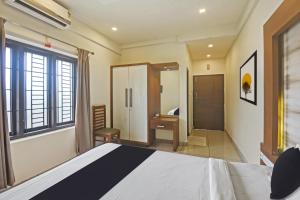 um quarto com uma cama grande e uma casa de banho em Hotel O AURA RESIDENCY em Kannur