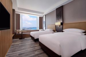 Ένα ή περισσότερα κρεβάτια σε δωμάτιο στο Batam Marriott Hotel Harbour Bay