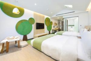 - une chambre avec un grand lit et une télévision dans l'établissement CHECK inn MAGI Kids Hotel, à Luodong