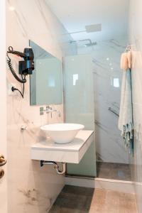 a bathroom with a sink and a mirror at Nikis Village in Poros