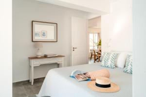 a bedroom with a bed with a hat on it at Nikis Village in Poros