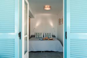 a bedroom with a bed with a table in it at Nikis Village in Poros