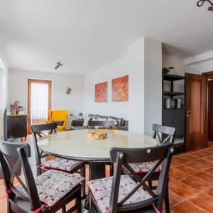 a dining room and living room with a table and chairs at Lioda Roccia in Masariè