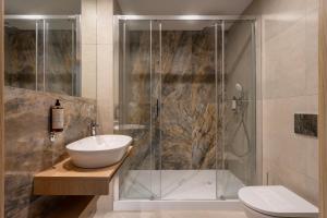 a bathroom with a shower and a sink and a toilet at Sea Shell Apartments Łukęcin in Łukęcin