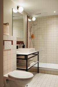 a bathroom with a toilet and a sink at Edgar Suites Montrouge in Montrouge