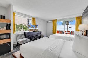 a hotel room with two beds and a television at Holiday Shores Myrtle Beach in Myrtle Beach