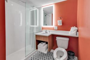 a bathroom with a toilet and a sink and a shower at Holiday Shores Myrtle Beach in Myrtle Beach