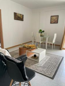 a living room with a table and chairs at Casa Do Encanto in Praia